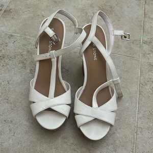 Never worn, white strapped, cork heel.